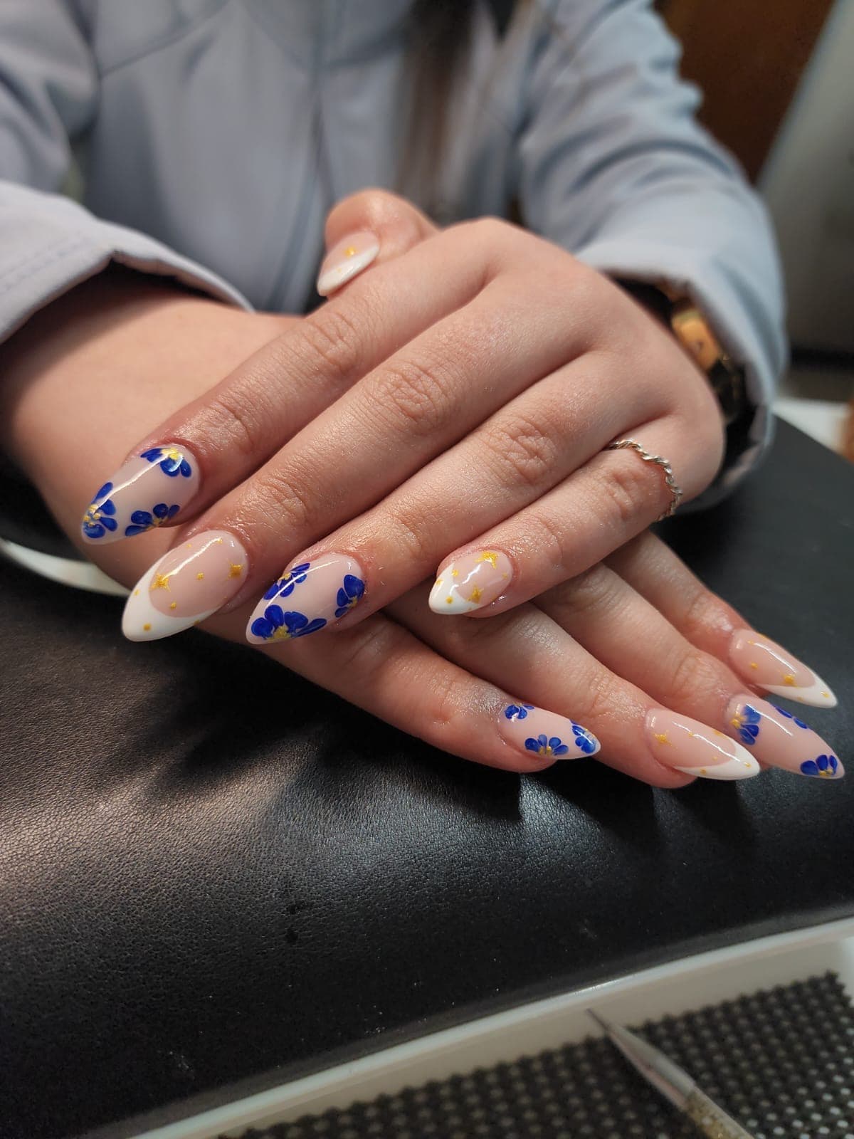 Floral blue and white nail art created at Olivia salon